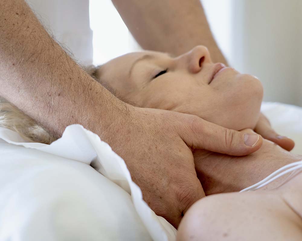 Man giving a woman a neck massage