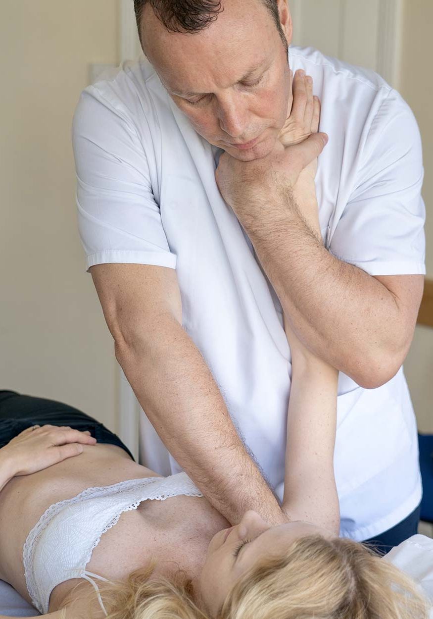 Robert Cartwright performing chiropractic treatment on girls arm